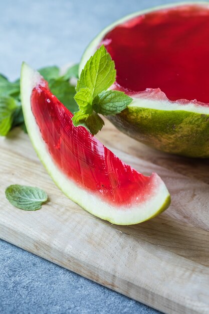 Homemade watermelon and mint dessert. Jelly in a watermelon  on a light background.