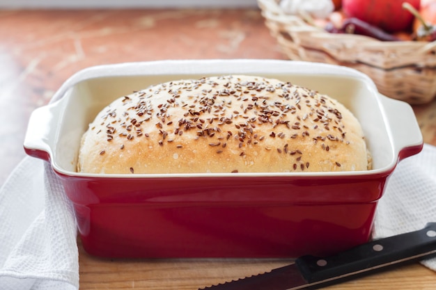 Homemade wheat bread with flax seeds in ceramic baking dish