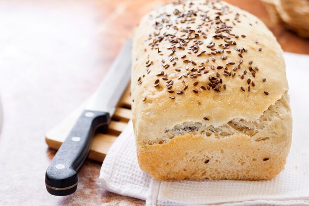 Homemade wheat bread with flax seeds on a kitchen table