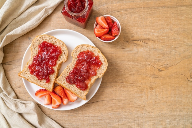 homemade whole wheat bread with strawberry jam and fresh strawberry