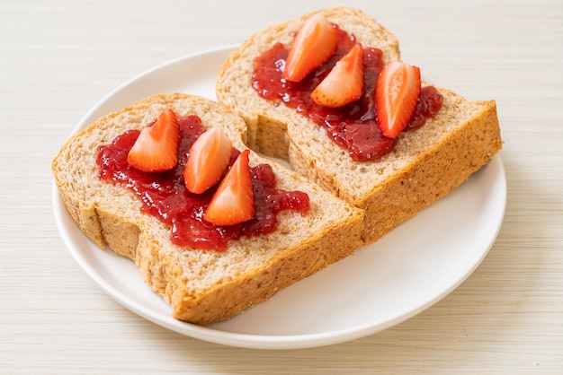 homemade whole wheat bread with strawberry jam and fresh strawberry