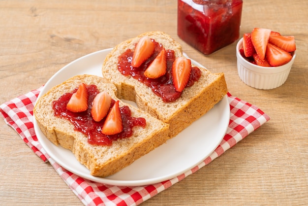 homemade whole wheat bread with strawberry jam and fresh strawberry