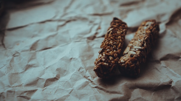 Homemade wholegrain cookies with oatmeal and sesame seeds on\
craft paper. food photo. recipe book, copy space. healthy vegan\
wholegrain cookies.