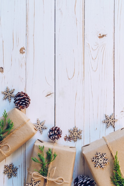 Homemade wrapped christmas gift box presents on a wood table background with space.