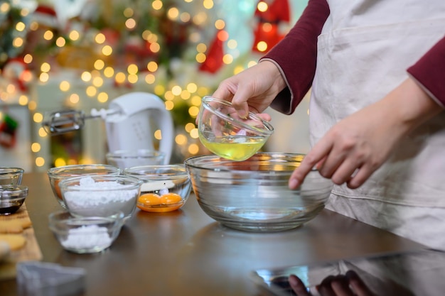 Homemade Xmas cookie for Christmas and Happy New Year. Woman cooking gingerbread with friend and Family on winter holiday at home.