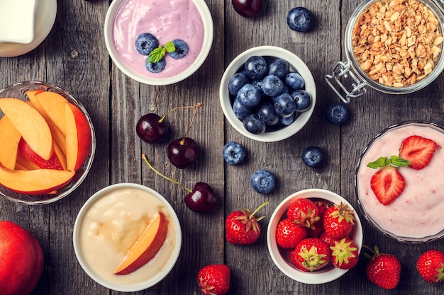 Homemade yogurt on a wooden background, top view. Healthy food, Diet, Detox, Clean Eating or Vegetarian concept.