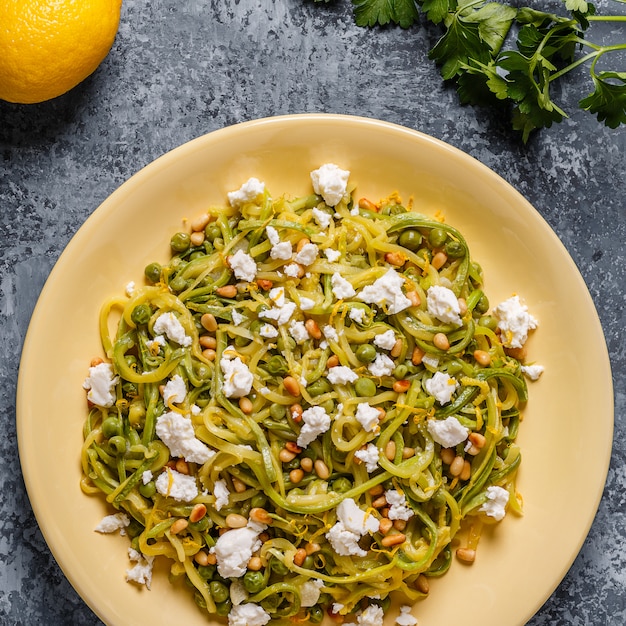 Homemade Zucchini noodles with pine nuts and feta