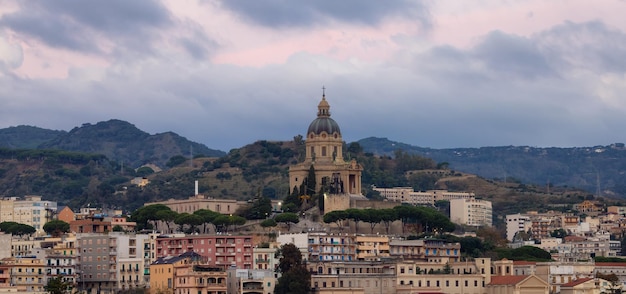 Homes and Apartment Buildings in a touristic city Messina Sicilia Italy Cloudy Sunrise Sky Aerial