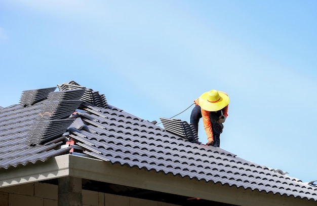 Homeworker doing roofing without safety protective gear house construction work safety concept