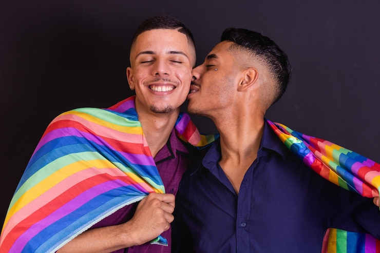 Homosexual couple on black background with lgbt flag
