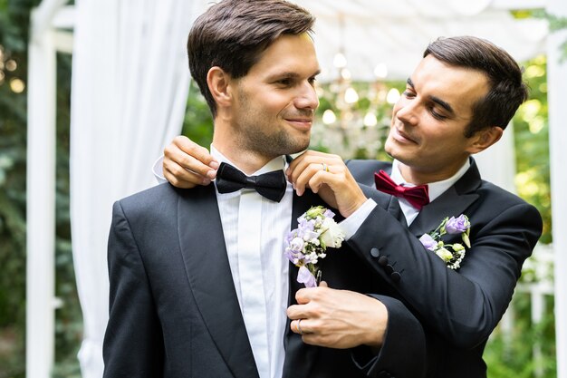 Homosexual couple celebrating their own wedding - LBGT couple at wedding ceremony, concepts about inclusiveness, LGBTQ community and social equity