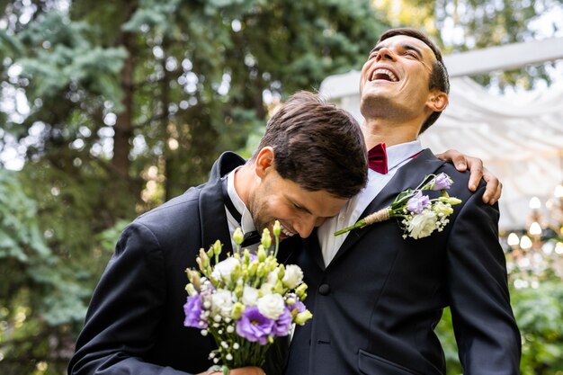 Homosexual couple celebrating their own wedding - LBGT couple at wedding ceremony, concepts about inclusiveness, LGBTQ community and social equity