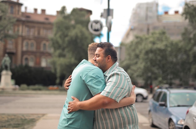 homosexual couple hugs each other on the street