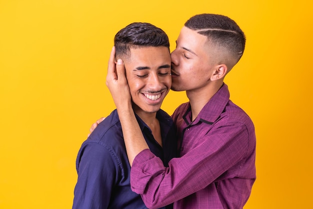 A homosexual couple on yellow studio background