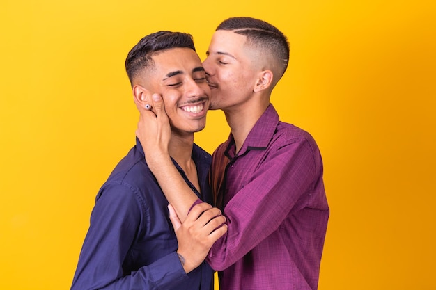 A homosexual couple on yellow studio background