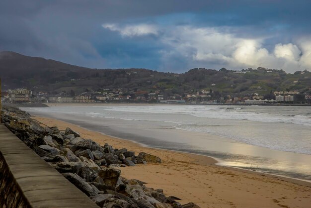 Hondarribia seen from Hendaye on a winter sunrise Along the coast the promenade the sandy beach