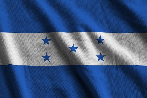 Photo honduras flag with big folds waving close up under the studio light indoors the official symbols and colors in banner