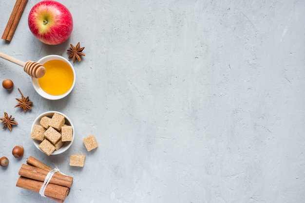 Honey and apple, brown sugar and anise with cinnamon on a light background