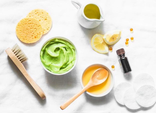 Honey and avocado face mask on light background top view Beauty youth skin care concept