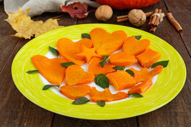 Honey Baked slices of pumpkin in the form of various figures mint leaves Childrens menu
