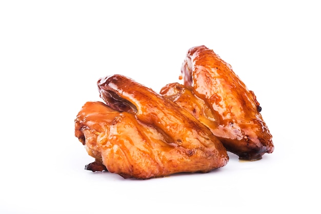 Honey-boiled chicken wings on white