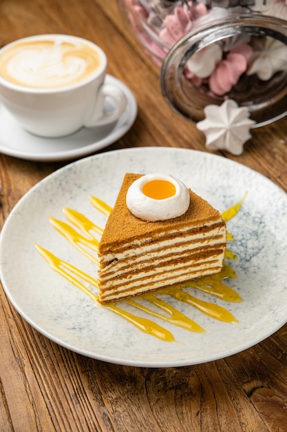 Honey cake in a plate on a wooden table