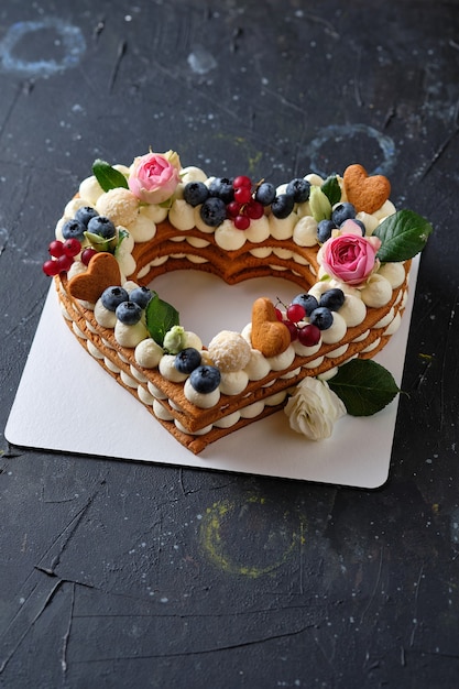 Honey cake with fresh blueberries herbs and cream cheese cream Dessert for a loved one Heart cake