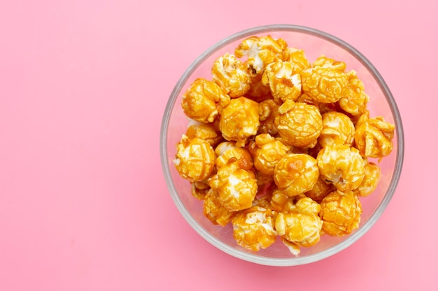 Honey caramel popcorn on pink background