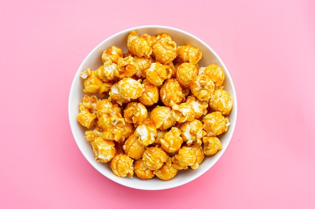 Honey caramel popcorn on pink background