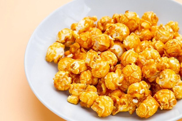 Honey caramel popcorn on white background