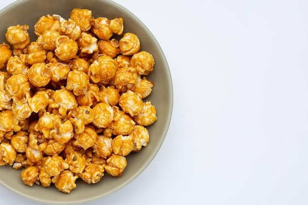 Honey caramel popcorn on white background