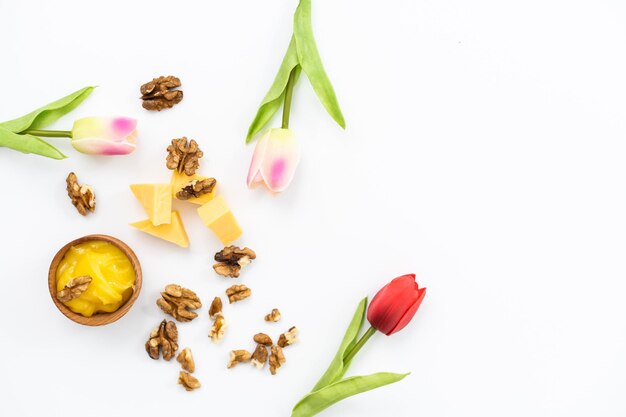 Honey and cheeses on white background.