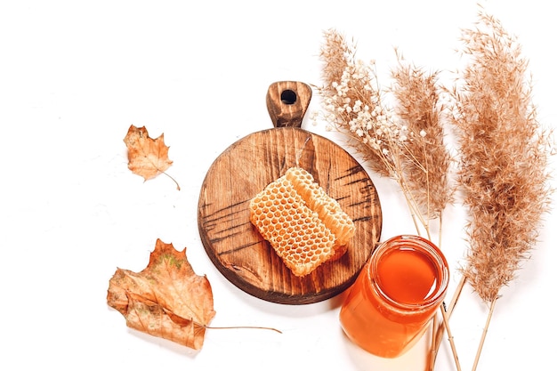 Photo honey comb and jar useful product autumn composition