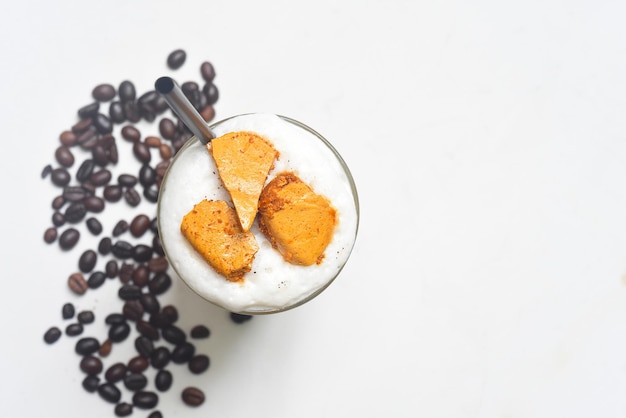 Honey comb latte with coffee beans isolated on white background  top view