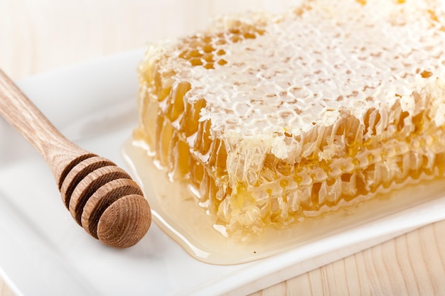 Honey comb on wooden table close up