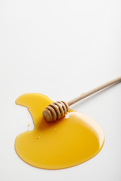 Honey dipper on white background Top view