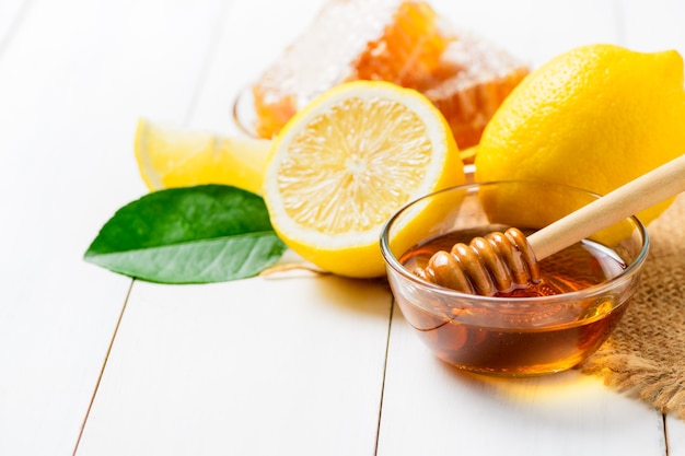 Honey dipper with honey bowl and lemons