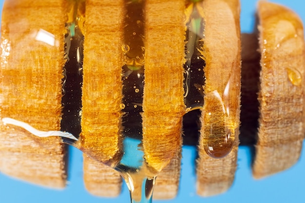 Honey drips closeup macro from a wooden ladle healthy eating concept diet