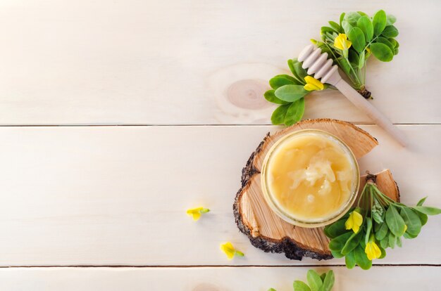 Honey from yellow acacia flower on wooden background