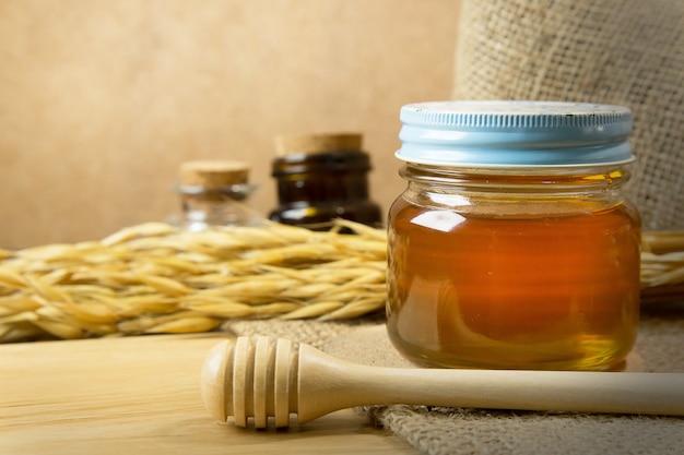  Honey in glass bottle on wood table.