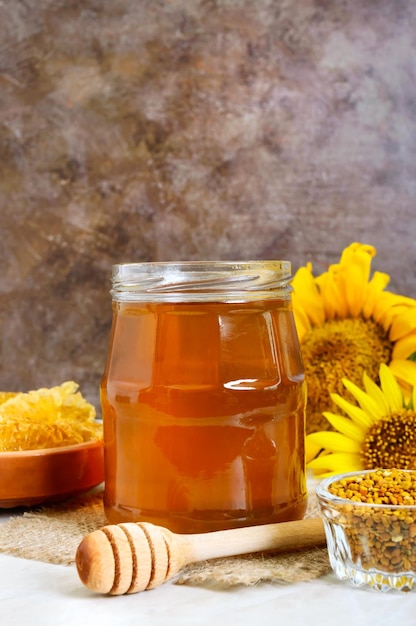 Honey in a glass jar honeycomb pollen Products of beekeeping The concept of healthy eating