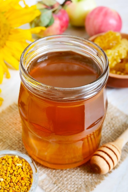 Honey in a glass jar honeycomb pollen Products of beekeeping