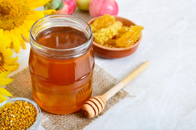 Honey in a glass jar honeycomb pollen Products of beekeeping