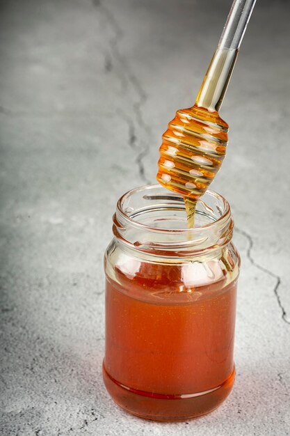 Honey in glass jar on the table