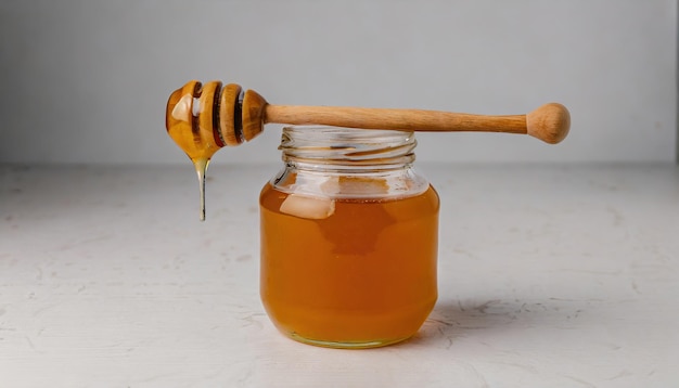 Honey in a glass jar with a wooden spoon dipper