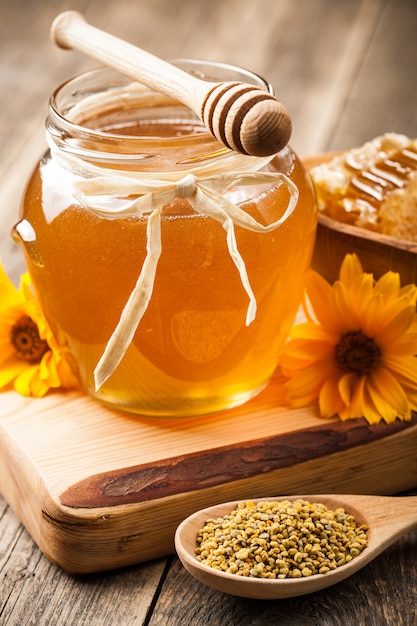 Honey in glass jar on wooden table