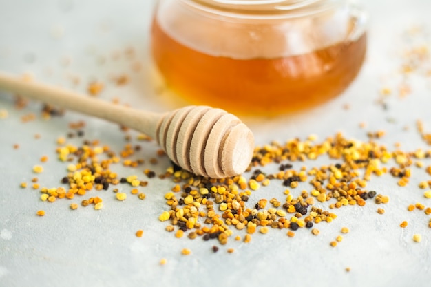 honey and honey spoon on a light background.