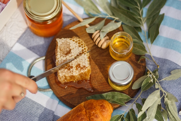 Honey honeycomb on wooden plate.