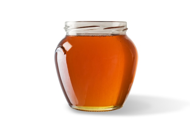 Honey in jar isolated on white surface.