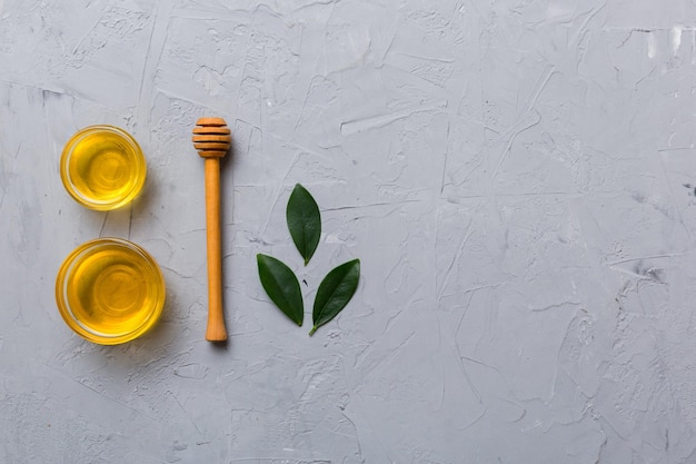 Honey jar with wooden honey dipper on white background top view with copy space Delicious honey bottle